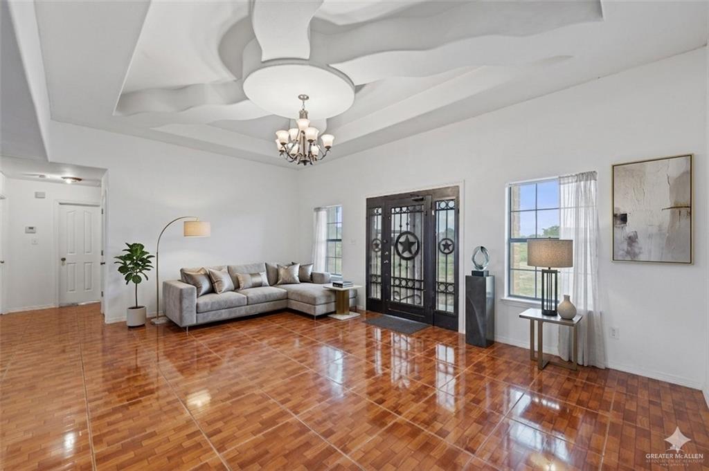 24175 Engleman Road Edcouch, TX 78538 - Photo 6 of 22 a living room with furniture and a chandelier