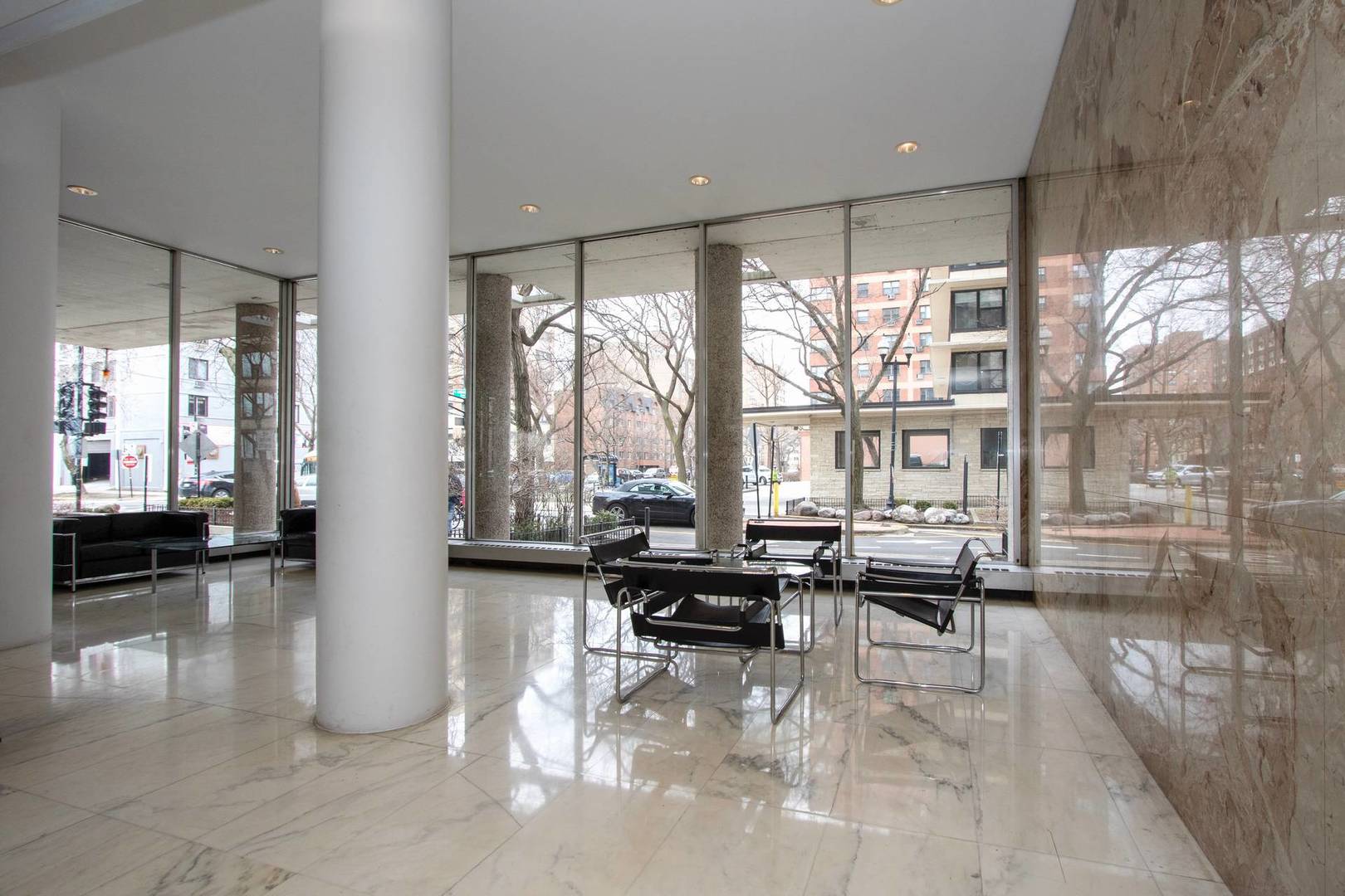 5757 North Sheridan Road, Unit 18J Chicago, IL 60660 - Photo 11 of 16 a lobby with furniture and floor to ceiling window