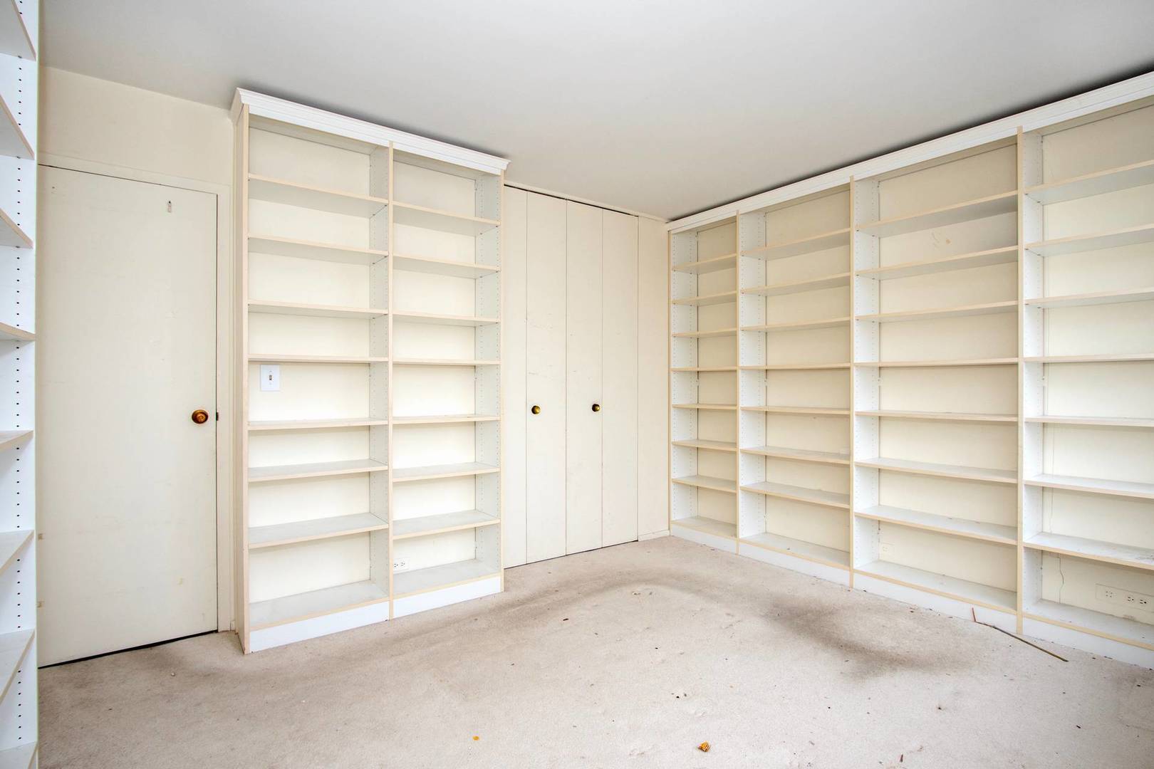5757 North Sheridan Road, Unit 18J Chicago, IL 60660 - Photo 15 of 16 a view of an empty room with a empty shelves
