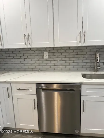 a close view of sink and cabinets