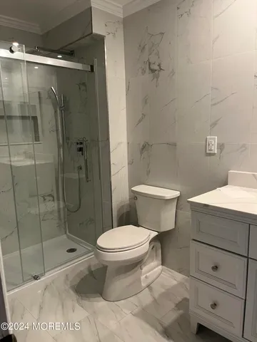 a bathroom with a toilet and a shower