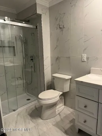 a bathroom with a toilet and a shower