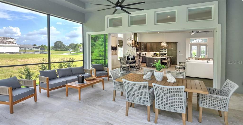 177 Aspen Way Palm Coast, FL 32137 - Photo 4 of 11 a living room with furniture and a floor to ceiling window