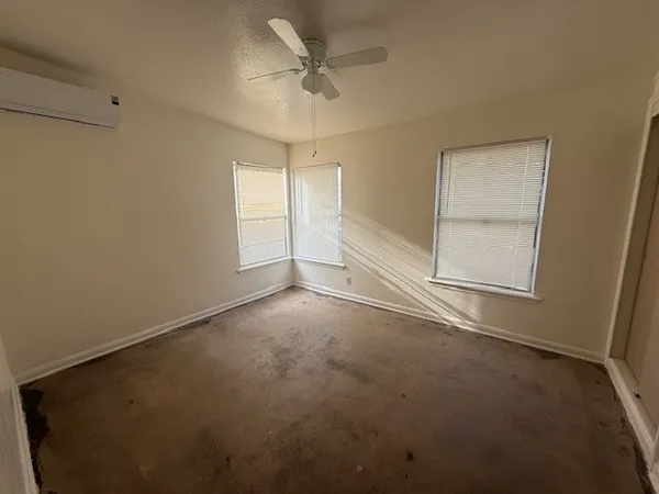an empty room with a empty space and a ceiling fan
