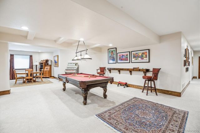 a room with pool table and windows