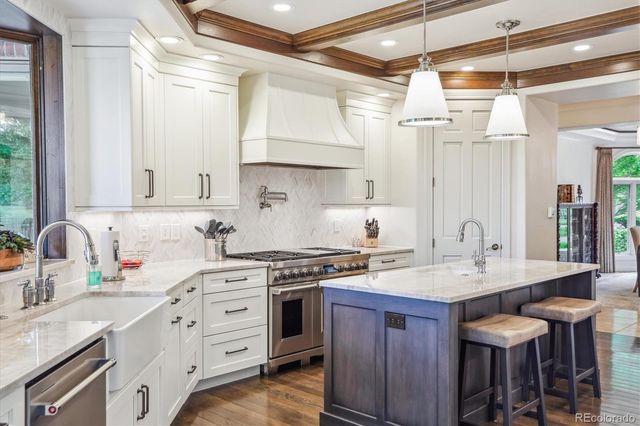 a kitchen with a stove a sink and a refrigerator