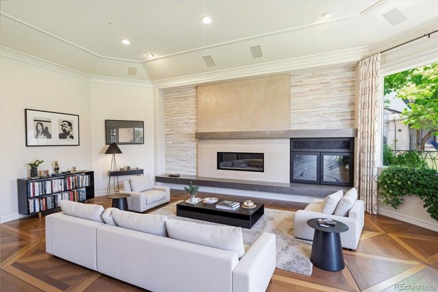 a view of a dining room with furniture a chandelier and wooden floor