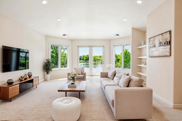 a dining room with wooden floor a chandelier a glass table and chairs