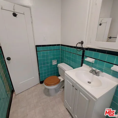 a bathroom with a sink toilet and mirror