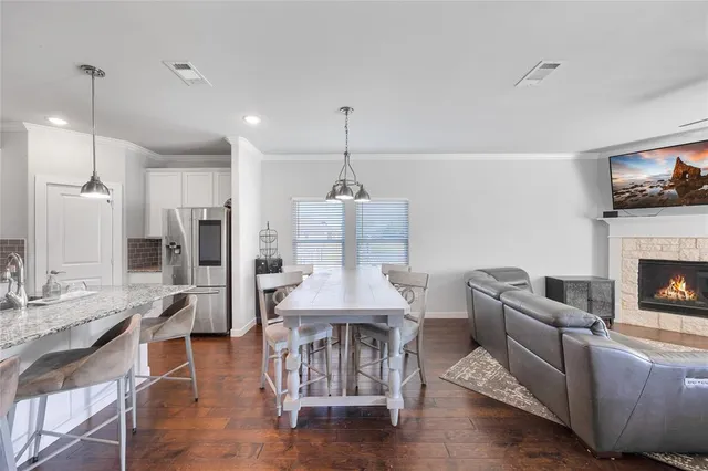 a kitchen with kitchen island granite countertop a sink and refrigerator