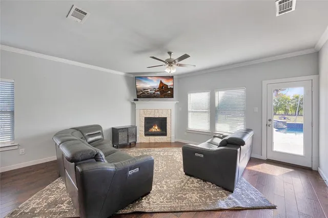 a living room with furniture a fireplace and a flat screen tv