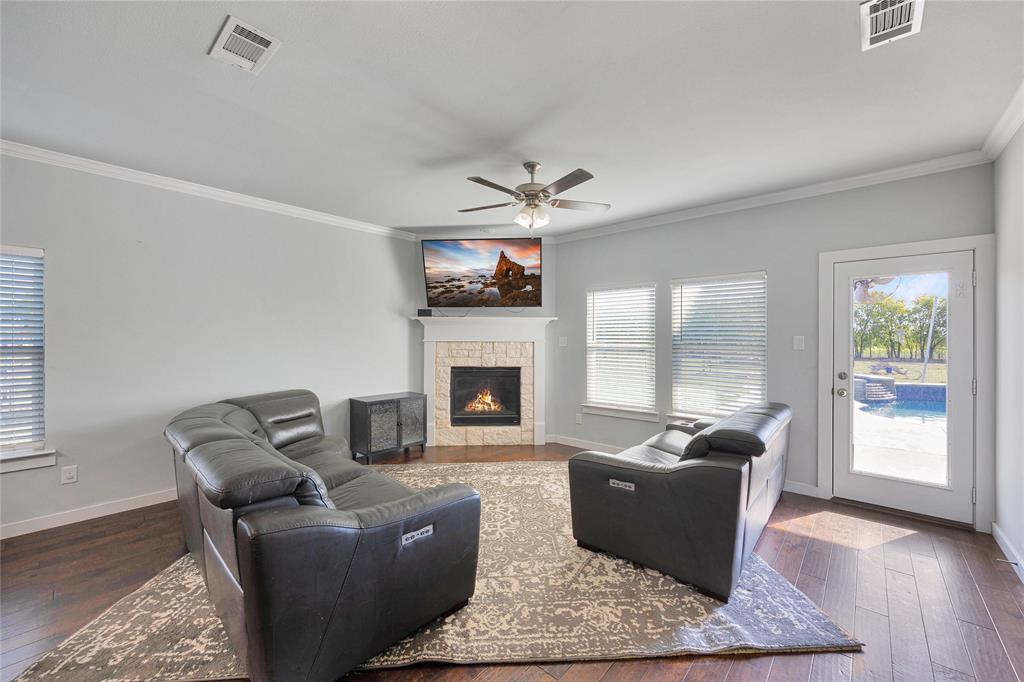 12616 Metz Road Sanger, TX 76266 - Photo 11 of 26 a living room with furniture and a fireplace