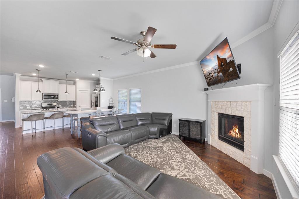 12616 Metz Road Sanger, TX 76266 - Photo 12 of 26 a living room with furniture a fireplace and a flat screen tv