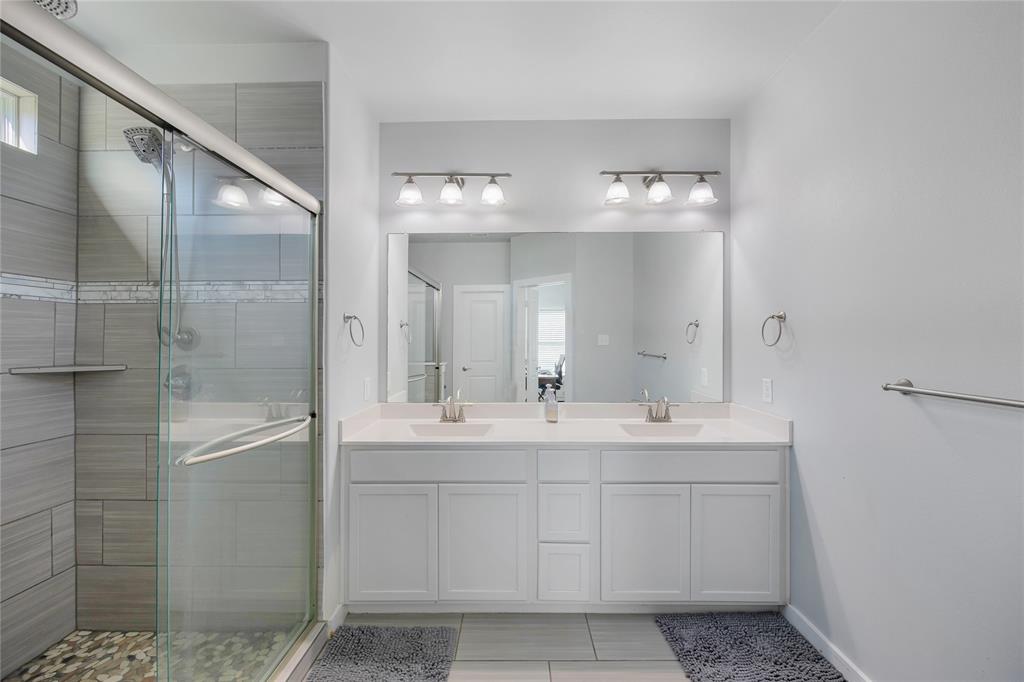 12616 Metz Road Sanger, TX 76266 - Photo 15 of 26 a bathroom with a double vanity sink and mirror