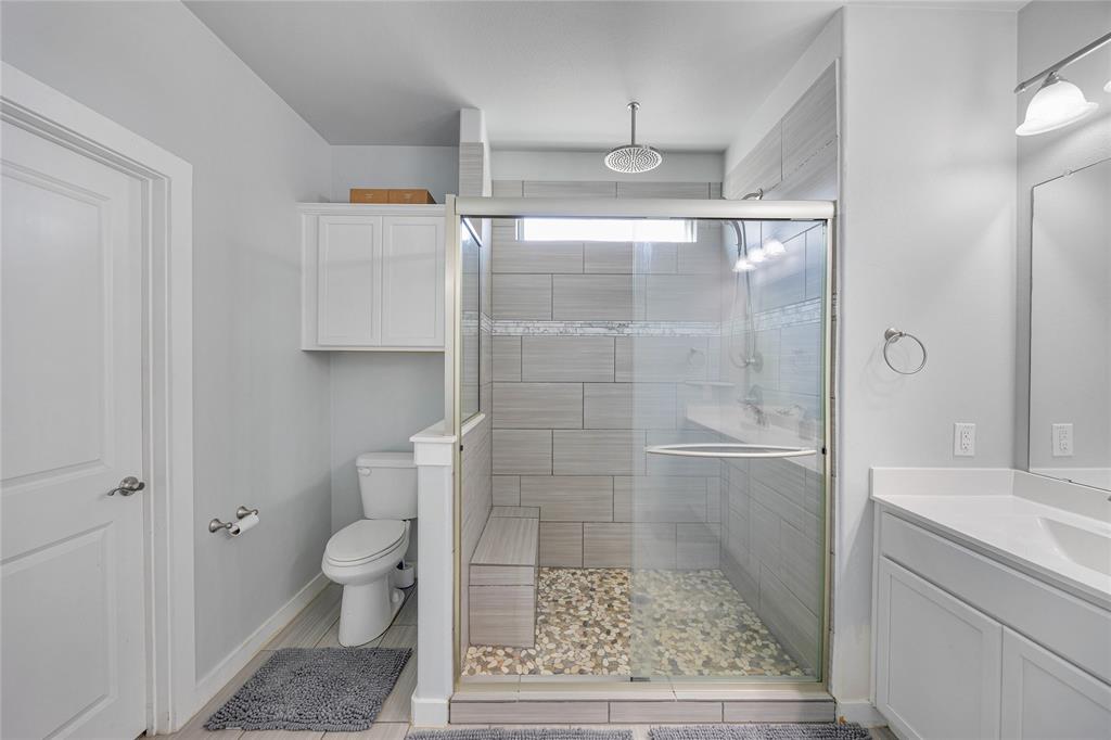 12616 Metz Road Sanger, TX 76266 - Photo 16 of 26 a bathroom with a granite countertop shower and toilet