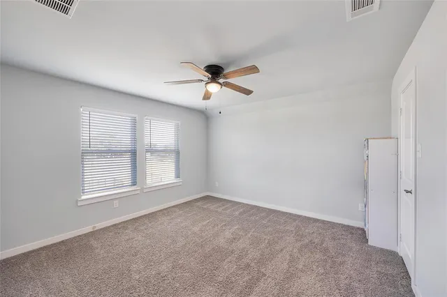 a bathroom with a granite countertop shower and toilet