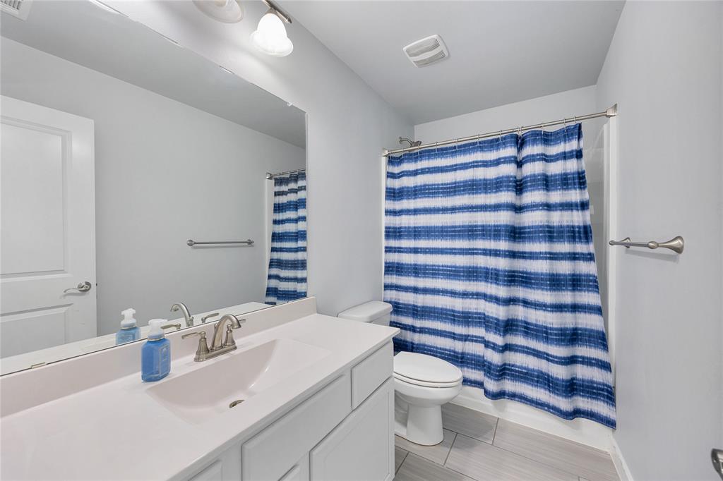 12616 Metz Road Sanger, TX 76266 - Photo 19 of 26 a bathroom with a sink a toilet a shower and a mirror