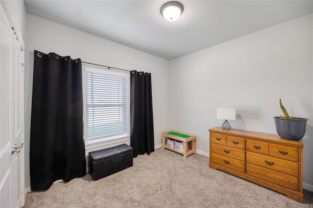 12616 Metz Road Sanger, TX 76266 - Photo 23 of 26 a bedroom with a bed and a closet