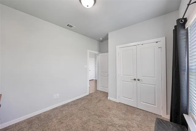 a bedroom with a bed and a closet