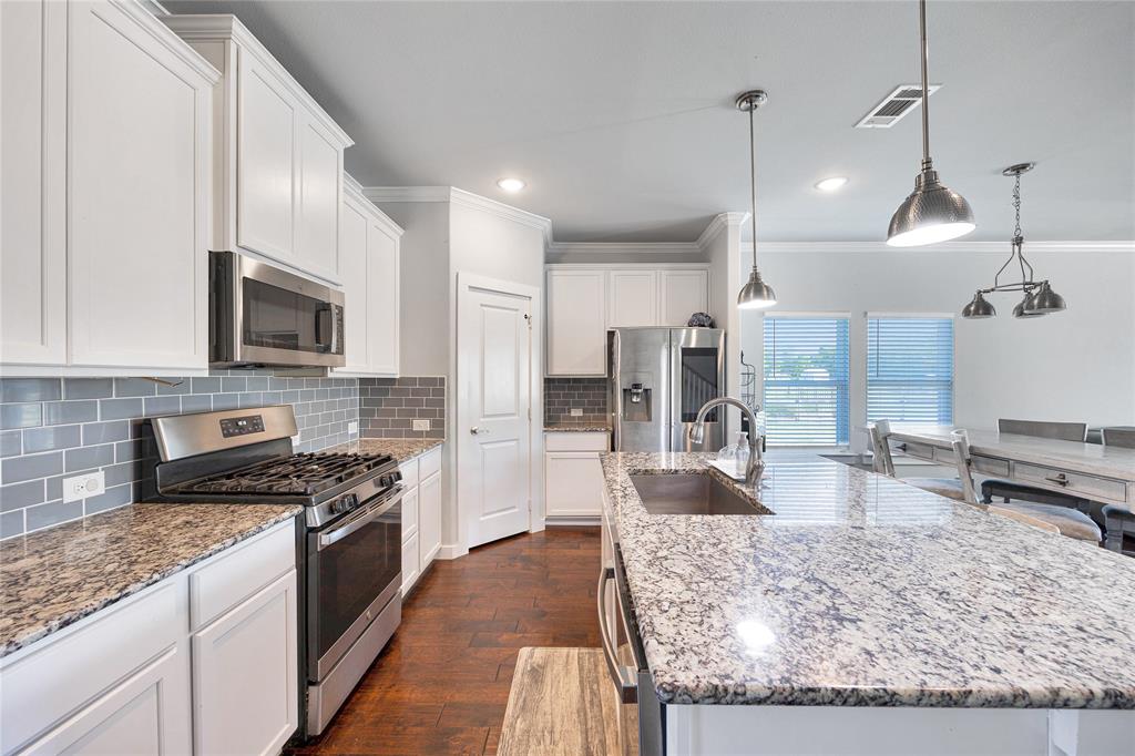 12616 Metz Road Sanger, TX 76266 - Photo 8 of 26 a kitchen with stainless steel appliances granite countertop a sink stove and refrigerator