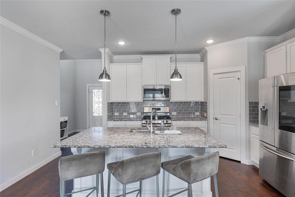 12616 Metz Road Sanger, TX 76266 - Photo 9 of 26 a kitchen with kitchen island granite countertop a sink and refrigerator