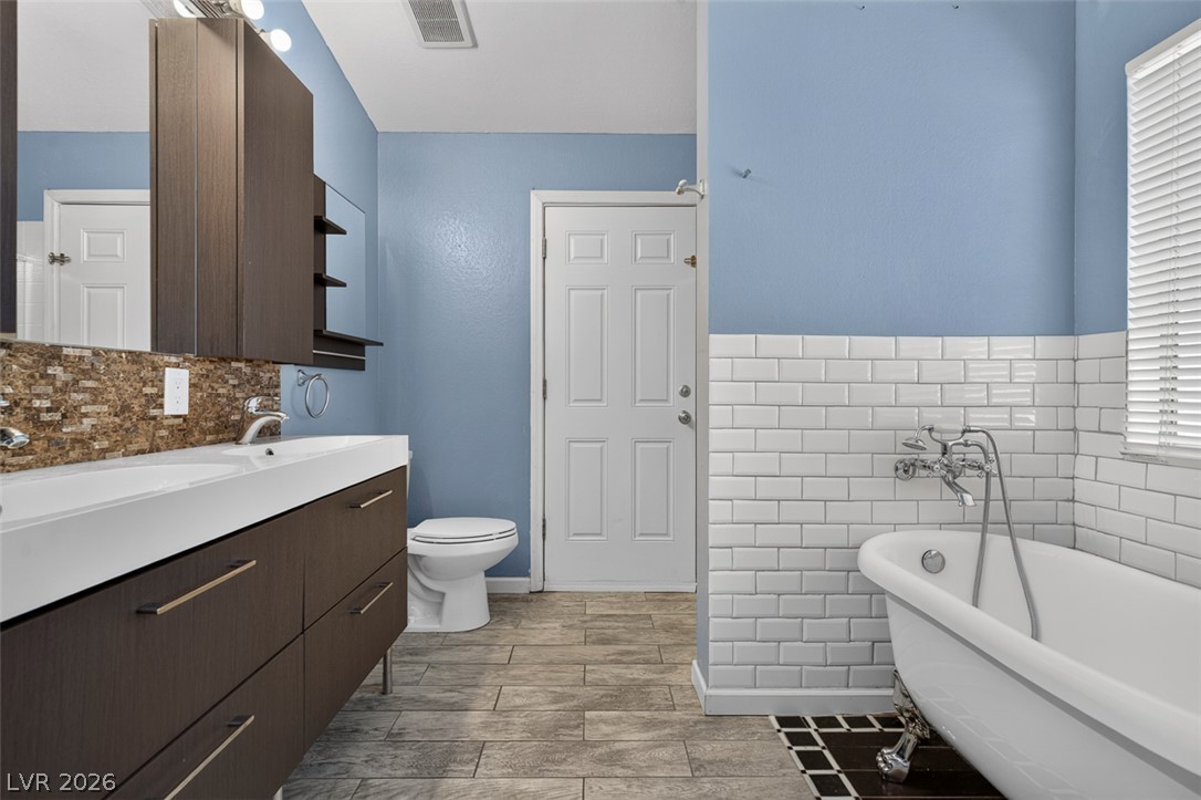 2609 Shakespeare Road Las Vegas, NV 89108 - Photo 20 of 41 A well-appointed bathroom features a contemporary double vanity and a classic clawfoot tub.