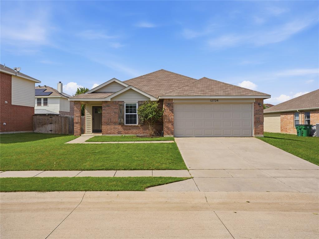 12724 Carpenter Lane Rhome, TX 76078 - Photo 36 of 37 Brick exterior with light siding accents, a two-car garage, and a covered front entry
