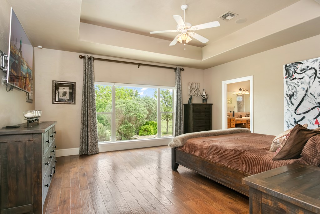 1320 Pass Creek Road East Center Point, TX 78010 - Photo 11 of 51 a bedroom with a bed and window