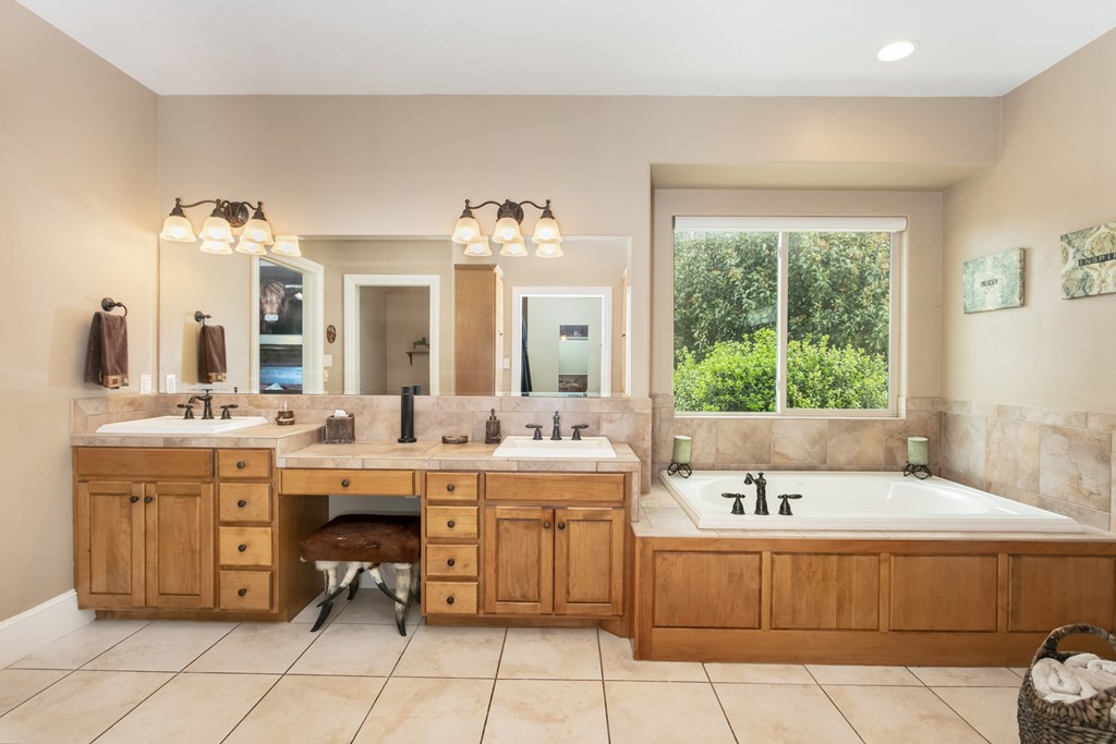 1320 Pass Creek Road East Center Point, TX 78010 - Photo 13 of 51 a spacious bathroom with a granite countertop sink mirror and bathtub