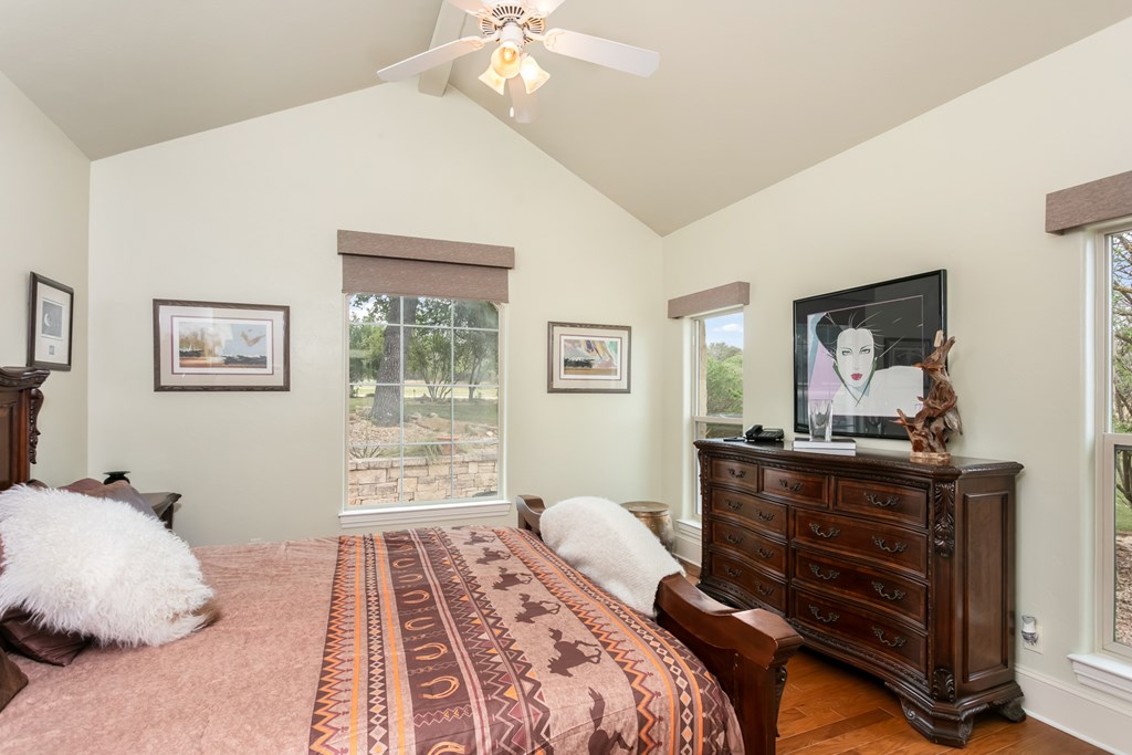 1320 Pass Creek Road East Center Point, TX 78010 - Photo 17 of 51 a bedroom with a bed and wooden floor