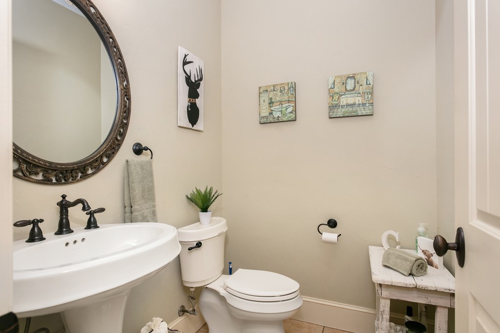 1320 Pass Creek Road East Center Point, TX 78010 - Photo 21 of 51 a bathroom with a sink mirror and toilet