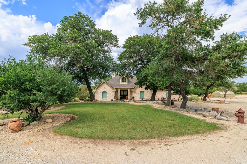 1320 Pass Creek Road East Center Point, TX 78010 - Photo 51 of 51 a front view of a house with a garden and trees