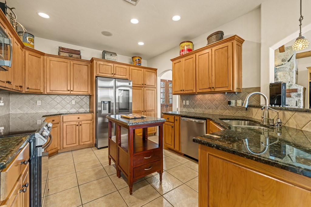 1320 Pass Creek Road East Center Point, TX 78010 - Photo 6 of 51 a kitchen with stainless steel appliances granite countertop a sink stove and cabinets