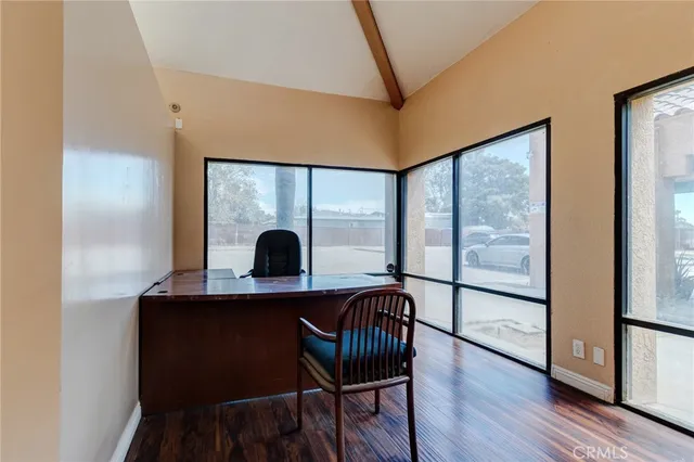 a view of a workspace with furniture and window