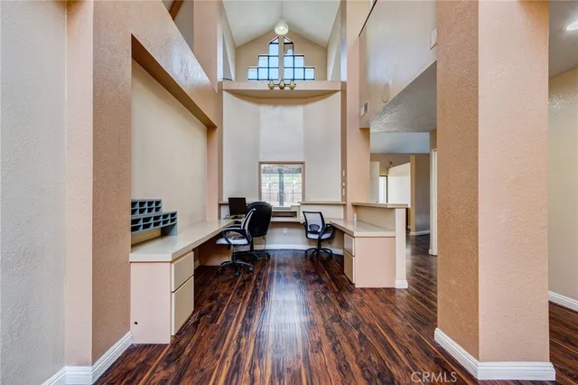 a view of a living room with furniture and wooden floor
