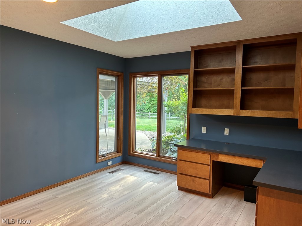8763 Timber Edge Drive North Ridgeville, OH 44039 - Photo 28 of 40 Unfurnished office with built in desk, light hardwood / wood-style floors, and a skylight