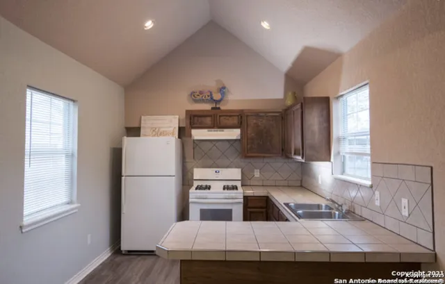 a kitchen with a refrigerator and a sink