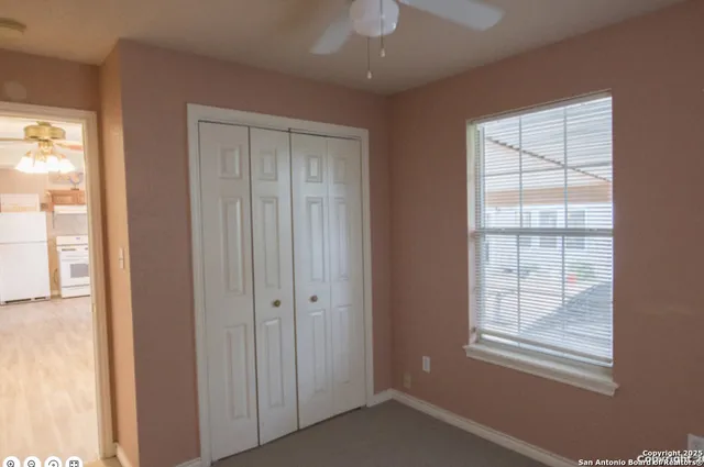 an empty room with windows and closet