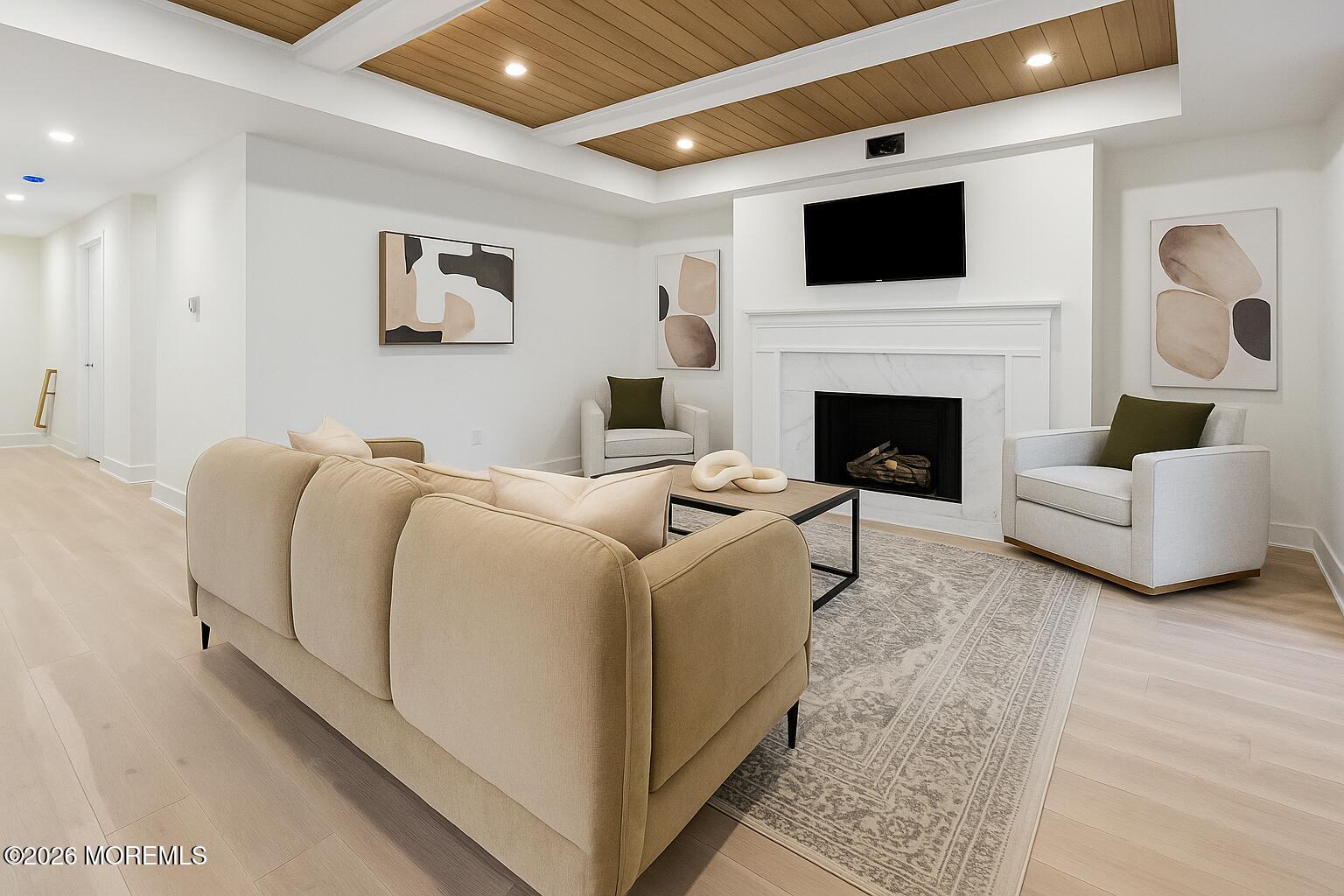 205 Edgemont Drive, Unit 1 Allenhurst, NJ 07711 - Photo 8 of 24 a living room with furniture a flat screen tv and a fireplace