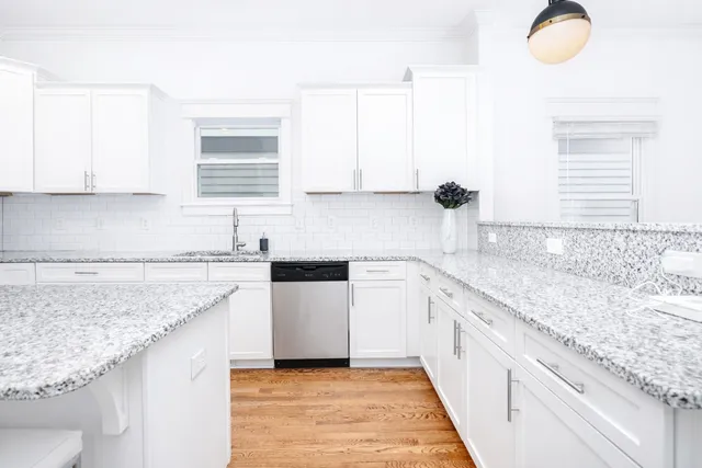 a kitchen with granite countertop a sink and a stove