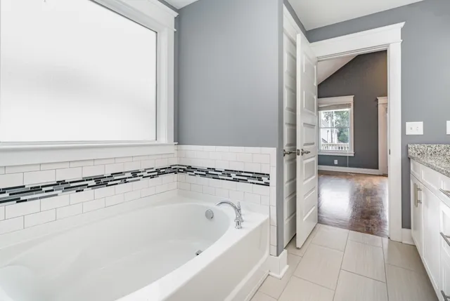 a bathroom with a bathtub and a shower