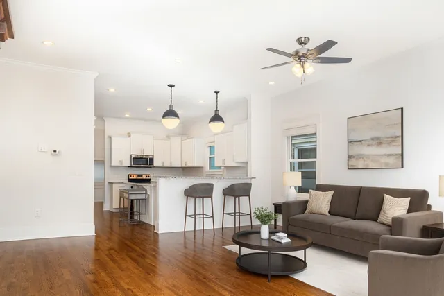 a living room with furniture and kitchen view