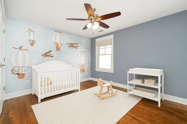 a bedroom with furniture and a wooden floor
