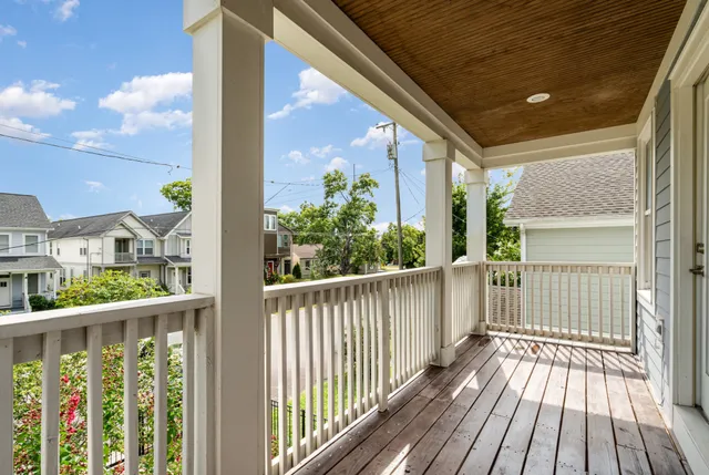 a view of a balcony with wooden floor