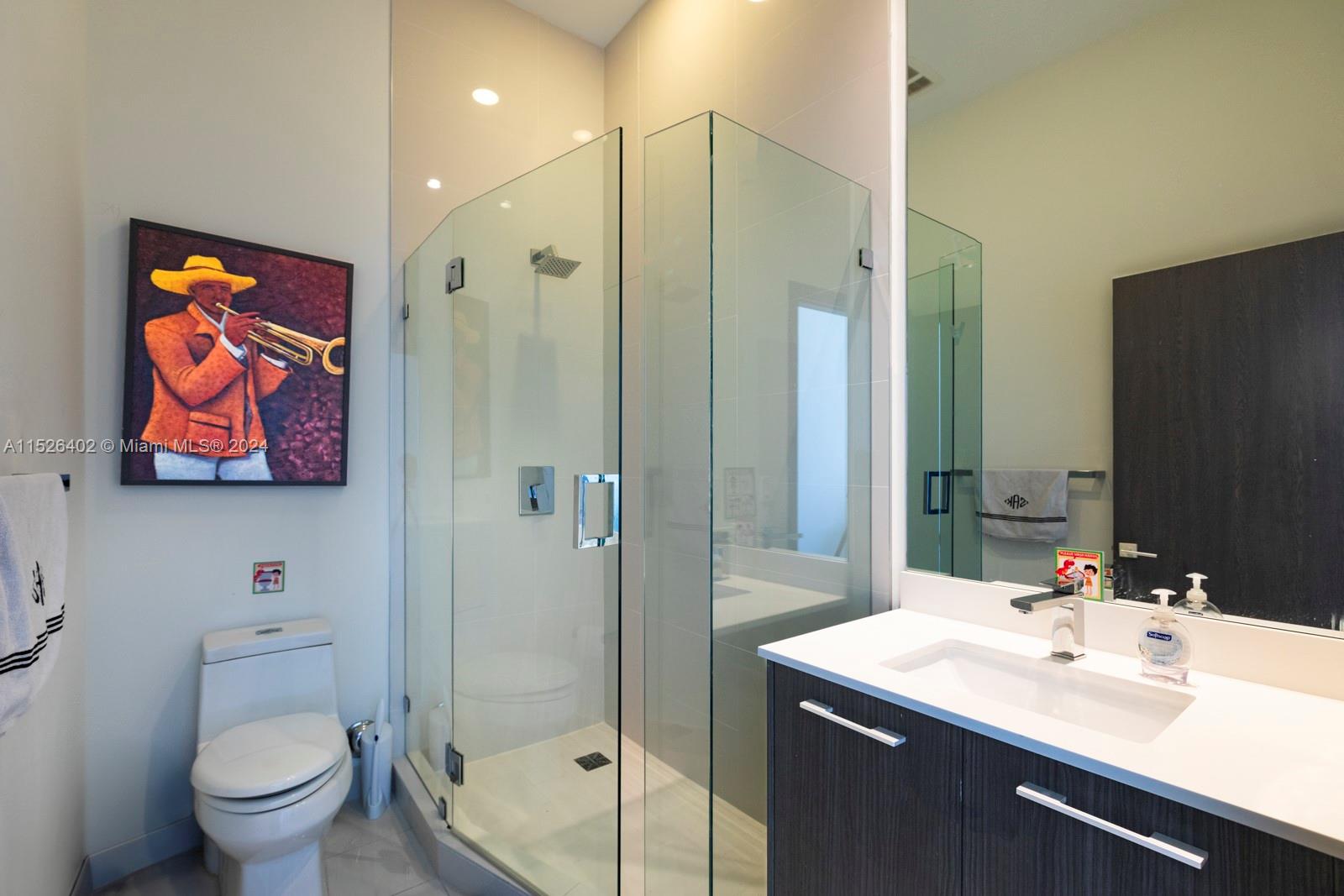 45 Southwest 9th Street, Unit PH4801 Miami, FL 33130 - Photo 24 of 41 a bathroom with a toilet a sink and glass door