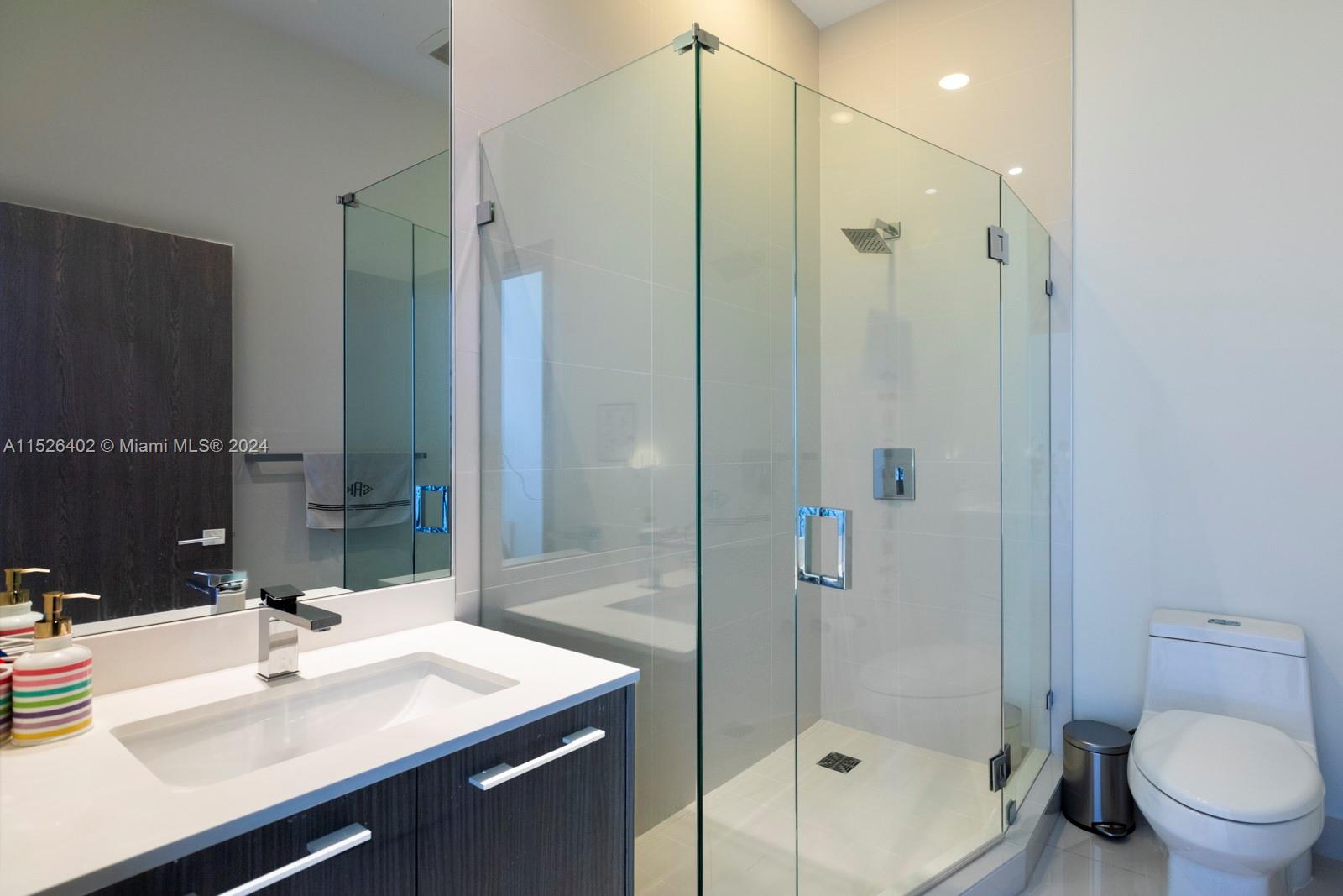 45 Southwest 9th Street, Unit PH4801 Miami, FL 33130 - Photo 26 of 41 a bathroom with a sink mirror toilet and shower