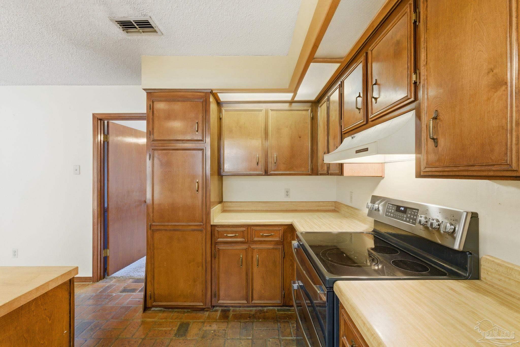 934 Springmier Place Pensacola, FL 32514 - Photo 11 of 49 a kitchen with stainless steel appliances granite countertop a sink a stove and a refrigerator
