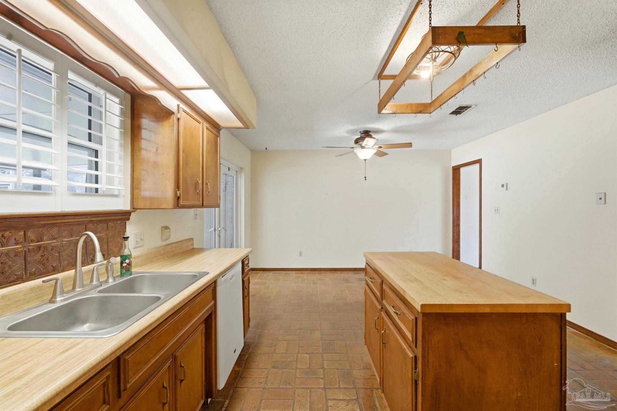 934 Springmier Place Pensacola, FL 32514 - Photo 12 of 49 a kitchen with a sink and a refrigerator