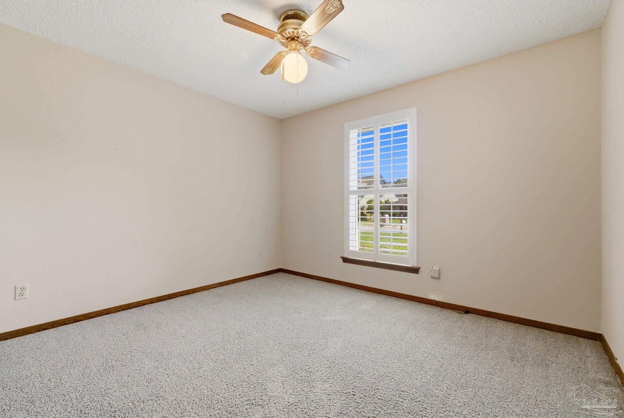 934 Springmier Place Pensacola, FL 32514 - Photo 14 of 49 an empty room with a window and a fan