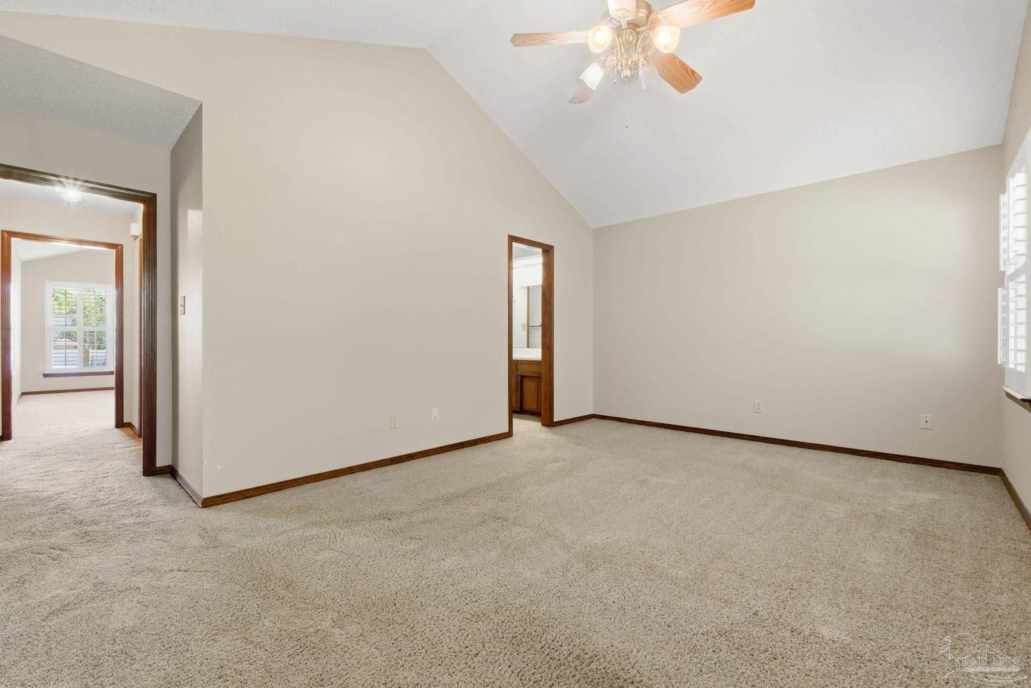 934 Springmier Place Pensacola, FL 32514 - Photo 20 of 49 an empty room with a chandelier fan and windows